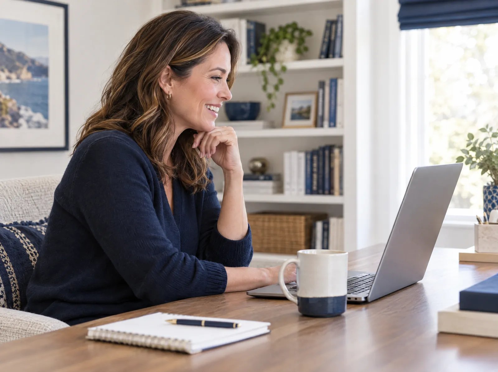 Business owner smiling during a video interview on her laptop in a home office