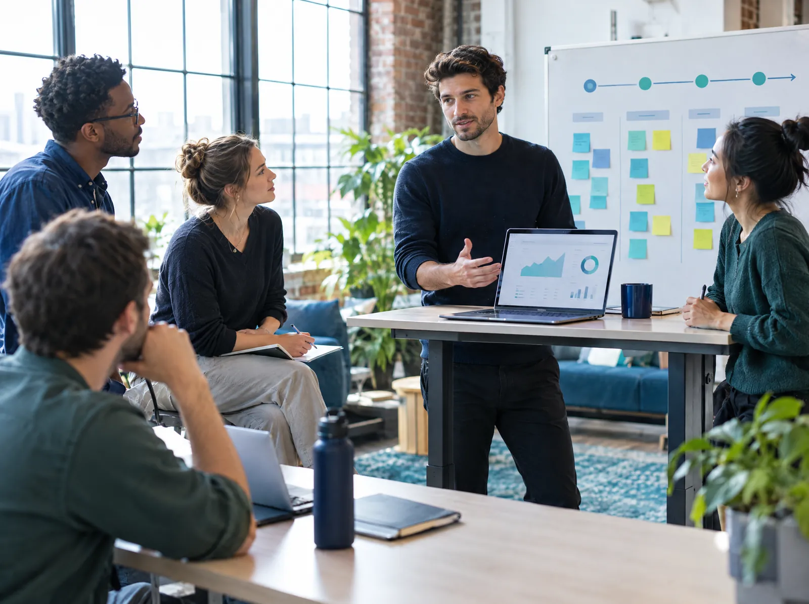 Startup founder at a standing desk with a product roadmap board behind