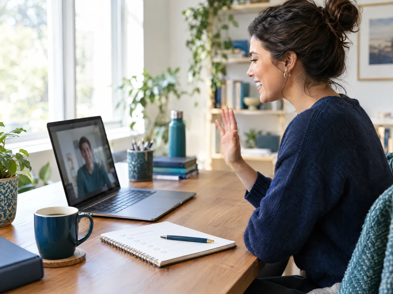 Founder welcoming a new remote team member on a video call with an onboarding checklist